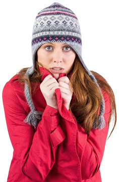 Cold redhead wearing coat and hat