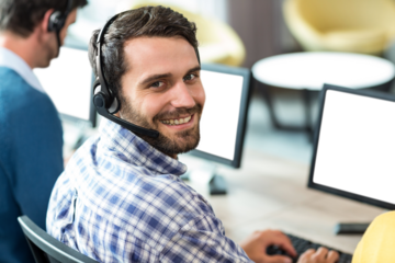Man smiling while using computer