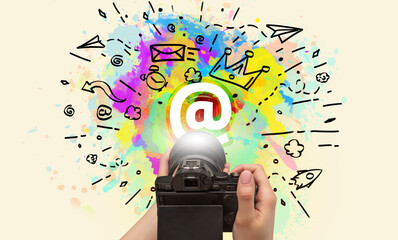 Close-up of a hand holding digital camera with abstract drawing concept