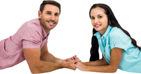 Happy couple laying on the floor face to face holding hands