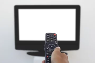 Gardinen Hand holding remote and changing channel © vectorfusionart
