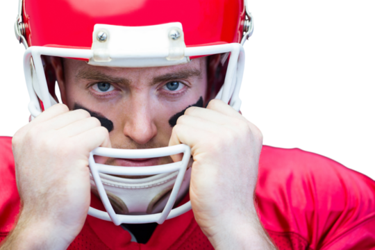 Portrait of american football player holding onto his helmet