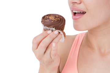 Smiling brunette holding chocolate cupcake