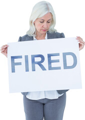 Upset businesswoman holding fired sign