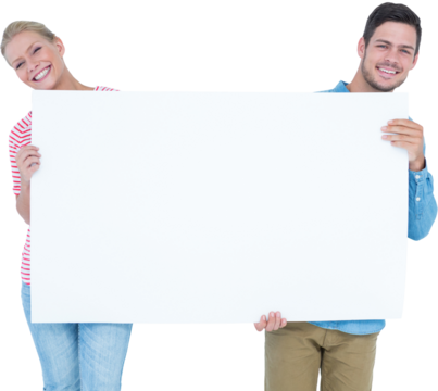 Smiling young couple holding a blank sign