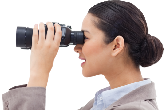 Side view of a businesswoman looking through binoculars