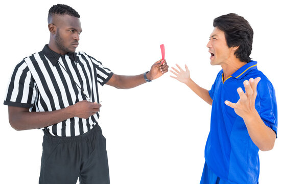 Referee showing red card to a player while holding whistle