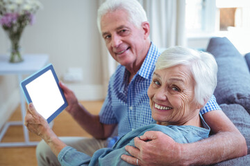 Portrait of senior couple holding digital tablet