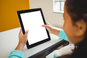 Girl sitting and using digital computer