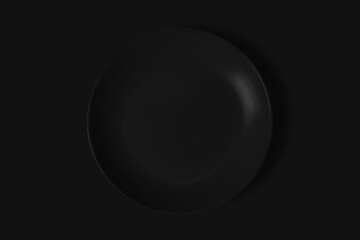 Black plate on a black background. View from above. Concept