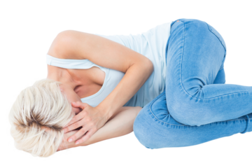 Sad blonde woman lying on the floor 