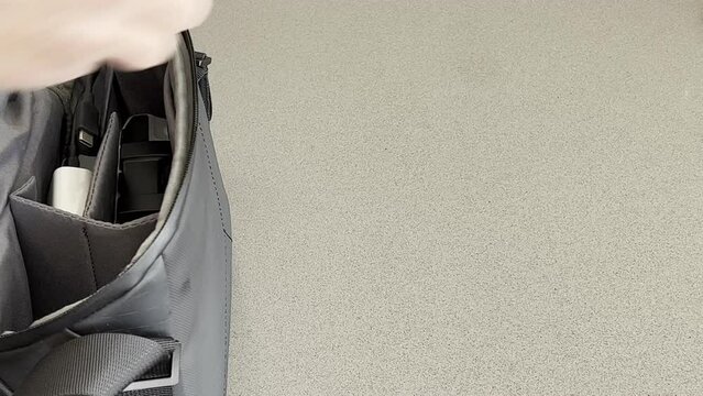 Removing a small drone and remote control device from storage bag