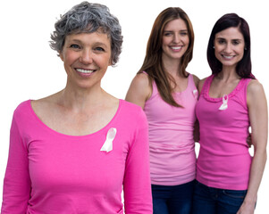 Smiling women in pink outfits posing for breast cancer awareness