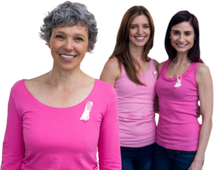 Smiling women in pink outfits posing for breast cancer awareness