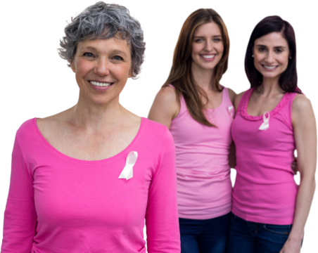 Smiling women in pink outfits posing for breast cancer awareness