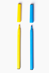 Two markers in a row on a white background