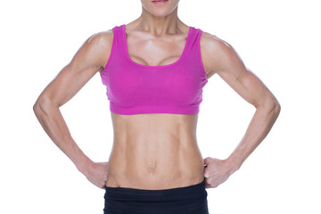 Female bodybuilder posing in pink sports bra and shorts mid section