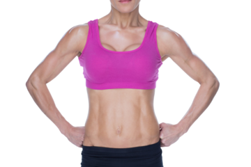 Female bodybuilder posing in pink sports bra and shorts mid section