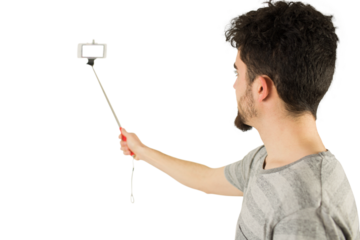 Casual man using a selfie stick
