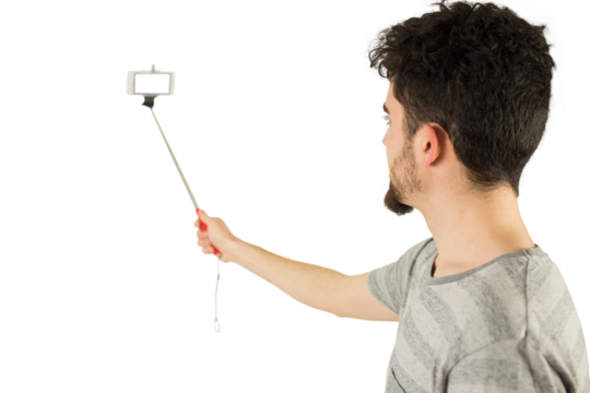Casual man using a selfie stick