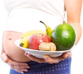 Pregnant woman showing fruit and veg 