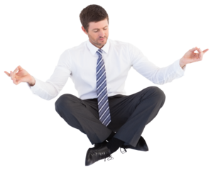 Businessman in suit sitting in lotus pose