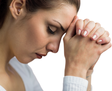 Peaceful woman praying with joining hands and eyes closed