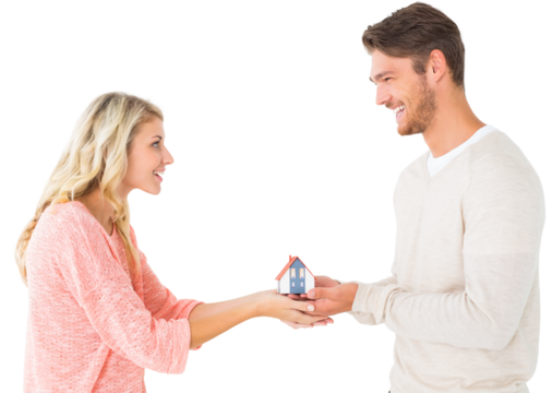 Attractive couple holding miniature house model
