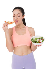 Pretty brunette eating pizza and holding salad 