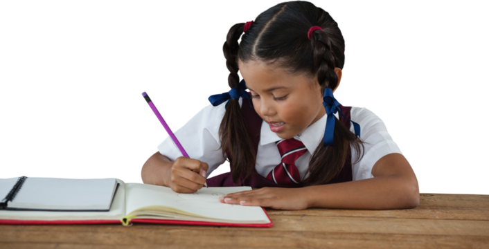 Schoolgirl writing in book at desk - Powered by Adobe