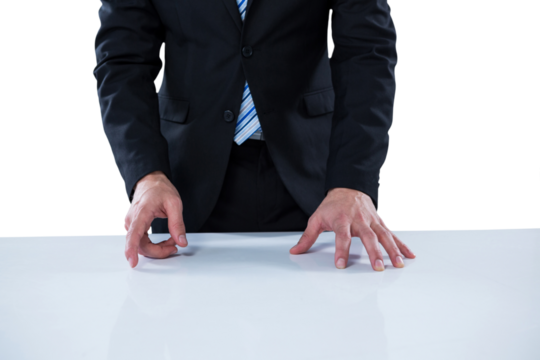 Midsection of businessman pretending to touch invisible technology