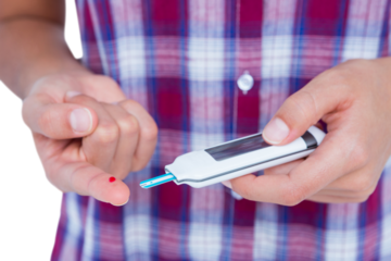 Woman testing her blood glucose level