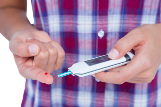Woman testing her blood glucose level