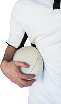 Midsection of rugby player holding ball