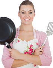 Confident woman holding frying pan and spatula
