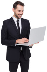 Smiling businessman standing and using laptop