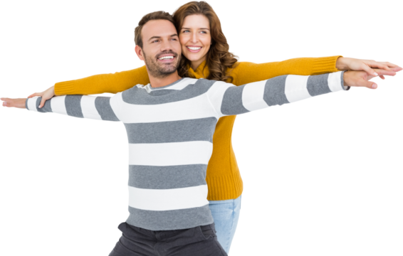 Young couple standing with arms outstretched