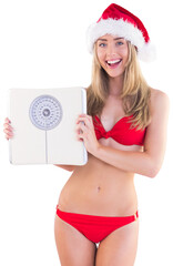 Festive fit blonde in red bikini showing scales