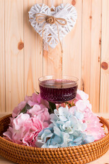 A glass glass-a creamer for drinks with colored drinks. Alcoholic fruit cocktail in a wicker basket...