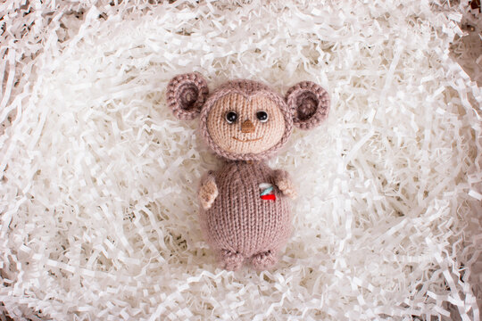 knitted brown Russian toy cheburashka with oranges. Handmade by hand made