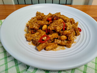 Orek Tempe, stir fry tempeh cooked with sweet soy sauce, peanut and red chili. Indonesian food with sweet and spicy taste