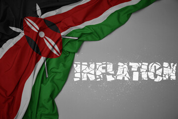 Fototapeta na wymiar waving colorful national flag of kenya on a gray background with broken text inflation. 3d illustration