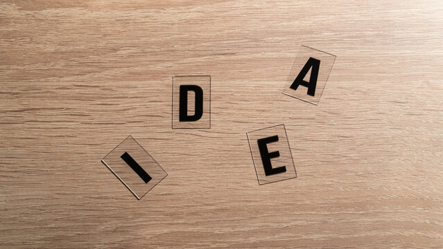 Idea concept. 'Idea' word on a wooden table. Letters on a wooden table. Motivational or inspirational concept. High angle view