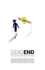Silhouette businesswoman walking to dead end signage . Concept of wrong decision in business or end of career path.