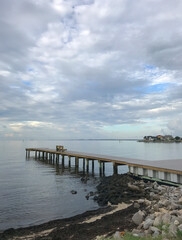 Fototapeta na wymiar Fishing Pier in Florida with riprap at water's edge