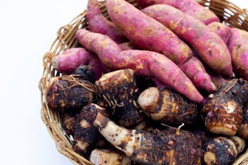 Sweet potato with taro in bamboo basket on white background.