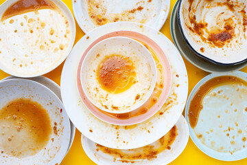 Dirty dishes on yellow background. Top view