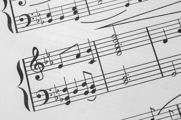 Sheet of paper with music notes as background, closeup view