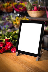 Digital tablet on table with flowers