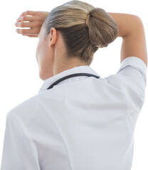 Wear view of confident female doctor looking through windows 